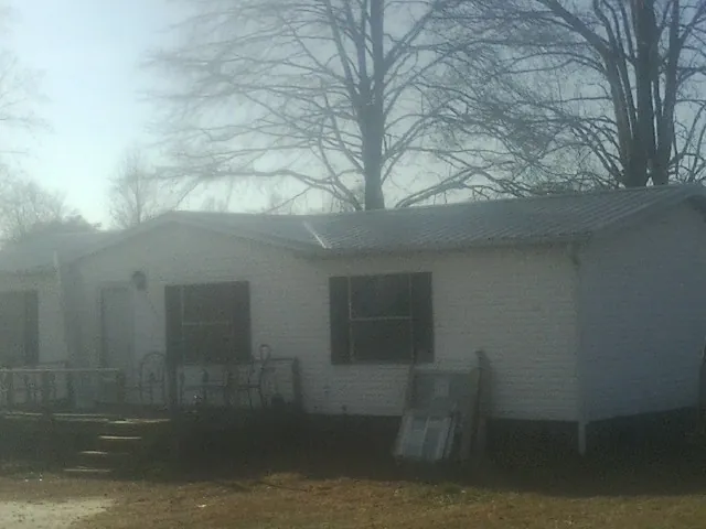 New metal roof on a white painted brick home on a foggy morning in Fairfield